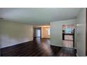 Open-concept living space with hardwood floors and views into the kitchen and dining area at 5177 Mccarter Sta, Stone Mountain, GA 30088