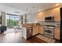 Bright living room with hardwood floors and large window providing natural light and views at 905 Juniper Ne St # 701, Atlanta, GA 30309