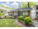 Charming brick home with landscaped front yard, walkway, and blue front door at 1300 North Ne Ave, Atlanta, GA 30307