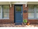 Inviting blue front door with brick surround, sidelight windows, and house number at 1300 North Ne Ave, Atlanta, GA 30307