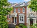 Charming brick townhome with a covered front porch and beautifully landscaped front yard at 4879 Seldon Se Way, Smyrna, GA 30080