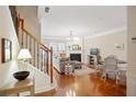 Cozy living room featuring hardwood floors, a fireplace, and staircase at 4879 Seldon Se Way, Smyrna, GA 30080