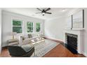 Cozy living room with fireplace, large windows, and natural light, creating a relaxing atmosphere at 1648 Danbury Parc Ne Pl, Brookhaven, GA 30319
