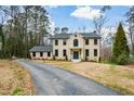 Classic brick home with a symmetrical facade, dark window frames, and an asphalt driveway at 805 Wesley Oak Rd, Atlanta, GA 30328