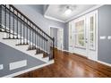 Elegant foyer with hardwood floors, a staircase, and a view of the front entrance at 1235 Renaissance Se Ct, Mableton, GA 30126