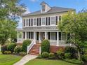 Attractive two-story home with a covered front porch and beautifully landscaped front yard at 1235 Renaissance Se Ct, Mableton, GA 30126