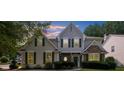 Beautiful two-story home with a combination of stone and siding exterior under a lovely evening sky at 3559 Reservoir Pass, Acworth, GA 30101