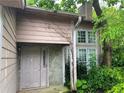 Entrance of a home with a stone column and overgrown greenery at 5035 Chadwick Ct, Decatur, GA 30035