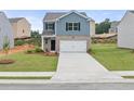 Inviting two-story home with a well-manicured lawn, a two-car garage, and a clean, concrete driveway at 504 Oak View Ln, Dallas, GA 30157