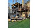 Outdoor living space with covered deck, patio with comfortable seating, and well-manicured landscaping at 5930 Shannon Drive Dr, Cumming, GA 30040