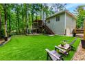 Spacious backyard featuring a multi-level deck, putting green, and ample space for outdoor entertaining at 5930 Shannon Drive Dr, Cumming, GA 30040