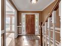 Light-filled foyer showcases hardwood floors, crown molding, and a view into the living spaces at 1685 Frazier Park Dr, Decatur, GA 30033