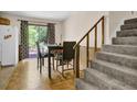 Cozy dining area with wood floors, sliding glass doors, and staircase at 504 Rock Meadow Dr, Stone Mountain, GA 30088