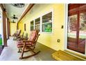 Close-up of covered porch with rocking chairs and wood trim at 5357 Highway 81, Loganville, GA 30052