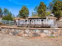 Stone community entrance sign reading 'The Oaks at Cedar Grove' surrounded by lush landscaping at 414 Oak View Ln, Dallas, GA 30157