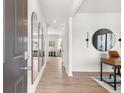Bright entryway with wood floors, a hall mirror, and an open view into the living room at 414 Oak View Ln, Dallas, GA 30157