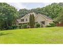 Charming home with a lush green lawn and mature trees providing shade and privacy at 5154 Meadowbrook Cir, Suwanee, GA 30024