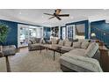 Comfortable living room featuring neutral sectional sofa, built-in shelving, and French doors at 5154 Meadowbrook Cir, Suwanee, GA 30024