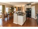 Kitchen area featuring dark wood floors, granite countertops, and stainless steel appliances at 5268 Mulberry Pass Ct, Hoschton, GA 30548