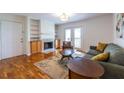 Inviting living room featuring a fireplace, hardwood floors, and access to a balcony at 1150 Collier Nw Rd # G8, Atlanta, GA 30318