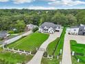 Expansive aerial view showcasing the property's manicured lawns, mature trees, and proximity to neighboring homes at 3735 Hamilton Mill Rd, Buford, GA 30519