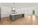 Open-concept kitchen boasts a large center island, stainless steel appliances, and custom cabinetry at 3735 Hamilton Mill Rd, Buford, GA 30519