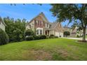 Attractive home featuring a well-kept lawn, established landscaping, and a two-car garage at 5925 Crescent Landing Dr, Cumming, GA 30028