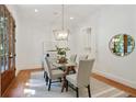 Elegant dining room with modern chandelier, glass table, and lots of natural light at 968 Dean Nw Dr, Atlanta, GA 30318