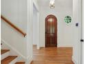 Bright foyer features hardwood floors, stairs, and an arched doorway at 968 Dean Nw Dr, Atlanta, GA 30318