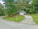 Home with an attached garage sits nestled on a corner lot with mature trees and a long driveway at 3235 Harms Way, Snellville, GA 30039