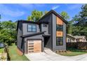 Stylish gray home with wood accents, modern garage door, well-maintained lawn, and inviting curb appeal at 2608 Argo Drive Southeast Se Dr, Smyrna, GA 30080