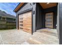 Close-up of the home's entrance, featuring a modern garage door and a stylish front door with glass panels at 2608 Argo Drive Southeast Se Dr, Smyrna, GA 30080