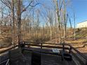 Wooden deck area surrounded by trees, with seating, offering a private outdoor space at 3415 Spring Valley Blvd, Atlanta, GA 30349