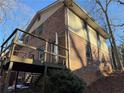 View of the home's exterior from the back showcasing the siding, brick and deck at 3415 Spring Valley Blvd, Atlanta, GA 30349