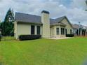 Well-maintained backyard featuring a lush lawn, trimmed shrubs, and a black iron fence at 518 Oriole Farm Trl, Canton, GA 30114