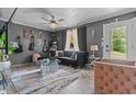 Stylish living room with modern decor, unique art, sleek furnishings, and large windows offering ample natural light at 5143 3Rd St, Morrow, GA 30260