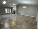 Open living room featuring new flooring, a cozy fireplace, skylight and a ceiling fan at 7123 Woodridge Ln, Union City, GA 30291
