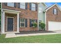 Inviting front entrance with brick facade, dark shutters, and landscaped garden beds at 2035 Stonebrook Dr, Austell, GA 30106