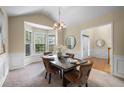 Elegant dining room with a large bay window and classic wainscoting details at 3610 Chestnut Meadows Dr, Douglasville, GA 30135