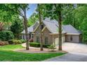 Charming brick home with a well-manicured lawn and mature trees, offering great curb appeal at 920 Waters Reach Ct, Alpharetta, GA 30022