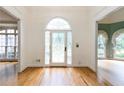 Bright entryway featuring hardwood floors, a decorative glass door, and open access to other rooms at 920 Waters Reach Ct, Alpharetta, GA 30022
