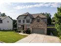 Inviting two-story home with gray siding, brick details, manicured lawn, and a two-car garage at 108 Fountain Oak, Villa Rica, GA 30180