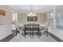 Formal dining room with stylish decor, featuring a modern chandelier and wainscoting at 1840 Tululah Trl, Smyrna, GA 30082
