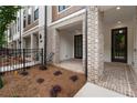 Welcoming front porch featuring brick pavers, a fenced-in yard, and stylish exterior details at 344 Olmstead Way # 32, Alpharetta, GA 30022