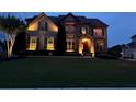 Charming two-story home with stone accents and tasteful landscaping at dusk at 4425 Martel Dr, Cumming, GA 30040