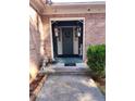 Inviting front entrance with decorative lanterns and charming dog statues at 6340 Koweta Rd, Fairburn, GA 30213