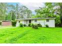Side view of a single-story home with a large green lawn and mature trees surrounding the property at 3133 Cottonwood Se Dr, Atlanta, GA 30316