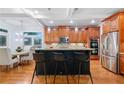Spacious kitchen with stainless steel appliances, center island, and hardwood floors at 10731 Bossier Dr, Alpharetta, GA 30022