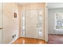 Bright foyer with wood floors, sidelight windows, and a white front door at 885 Falling Water Ln, Norcross, GA 30093
