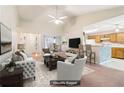 Staged living room showcases an open floor plan, seamlessly connecting to the dining area and kitchen at 885 Falling Water Ln, Norcross, GA 30093